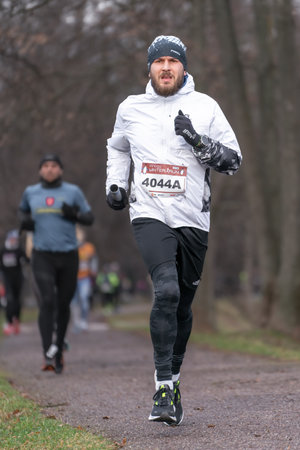 Ostrava, Czechia - 02.04.2023: Vertical shot of male runners in sportswear competing during winter amateur run race. Run competition during cold winter day. Innogy winter run.のeditorial素材