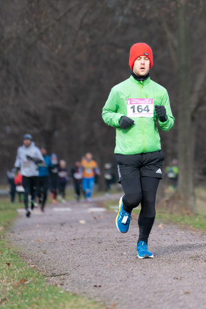 Ostrava, Czechia - 02.04.2023: Vertical shot of male runners in sportswear competing during winter amateur run race. Run competition during cold winter day. Innogy winter run.のeditorial素材