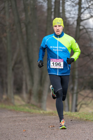 Ostrava, Czechia - 02.04.2023: Vertical shot of male runners in sportswear competing during winter amateur run race. Run competition during cold winter day. Innogy winter run.のeditorial素材