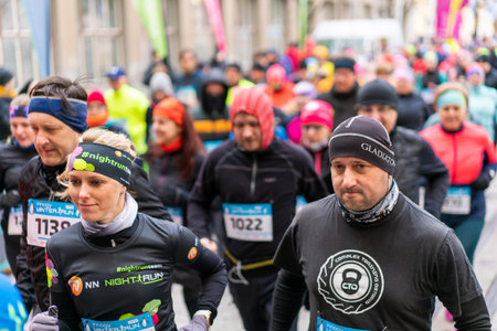 Ostrava, Czechia - 02.04.2023: Large group of people of all ages at the start of an amateur winter run race in the city. Competitors of Innogy winter run in Ostrava. Outdoor activities for all people.のeditorial素材