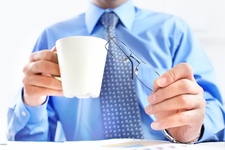 Businessman with a cup having lunch 
の写真素材
