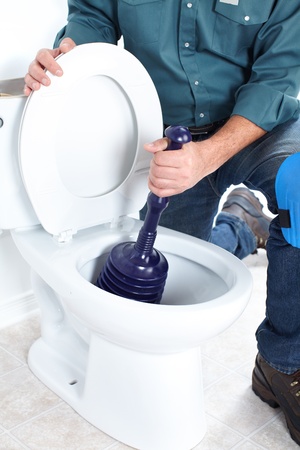 Plumber with a toilet plunger 
の写真素材