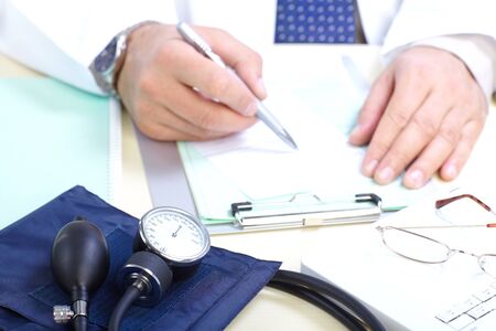 Medical doctor holding a blood presure sphygmomanometer with stethoscope
の写真素材