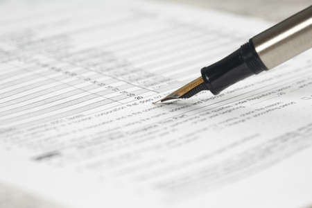 Pen and bank bills on a table at officeの写真素材