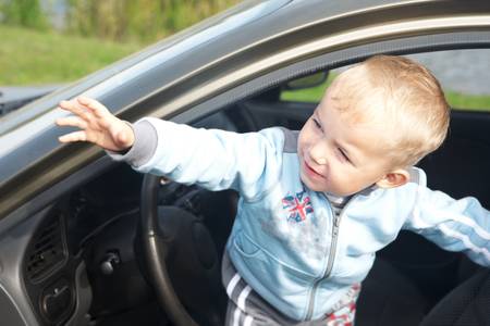 Funny boy car driver with the steering wheelの写真素材