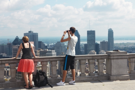 The young man and woman look at skyscrapersの写真素材