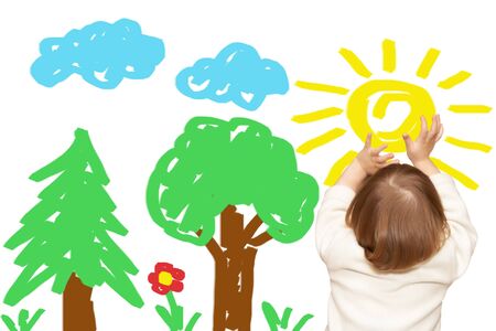 The small girl has drawn a wood and skyの写真素材