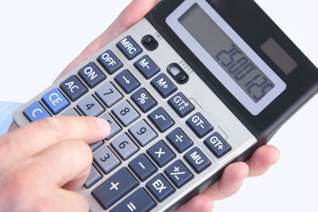 Mature businessman and calculator. Calculation at office