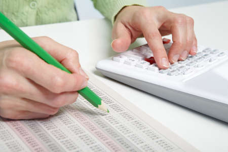 Businesswoman working in the office with calculator