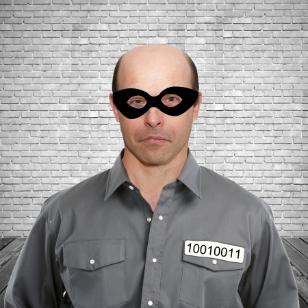 Portrait of a criminal in prison cell on a white backgroundの写真素材