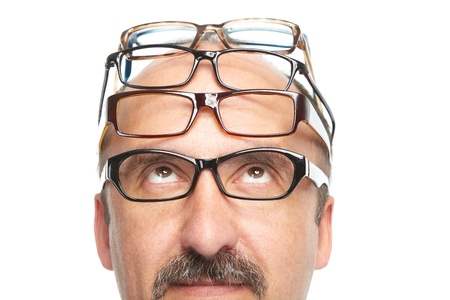 Businessman and a lot of spectacles on a white backgroundの写真素材