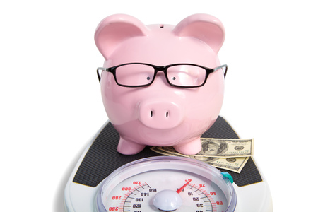 Pig bank and scales  Over white backgroundの写真素材