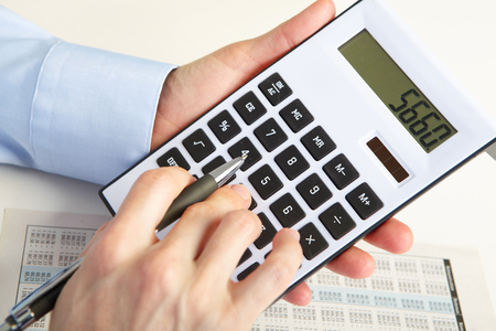 Businessman working with calculator in the officeの写真素材