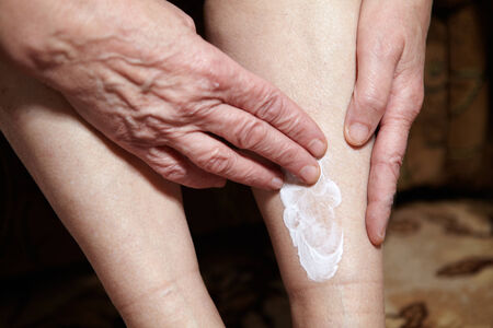 Legs of senior woman. Feet care and massage