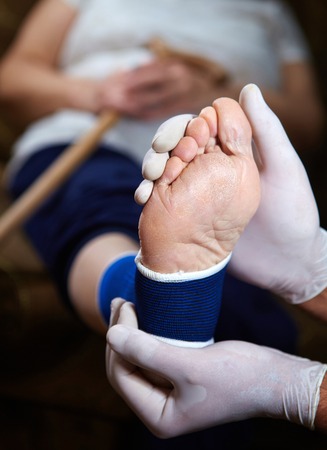 Doctor doing a bandage for patient. First aidの写真素材
