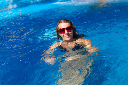 Woman swimming in the pool. Sport and recreation concept