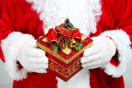 Hands of Christmas  Santa Claus with giftの写真素材