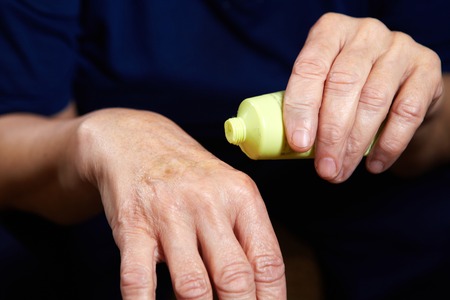 Senior woman with anti aging cream for hands