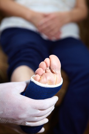 Doctor doing a bandage for patient. First aidの写真素材