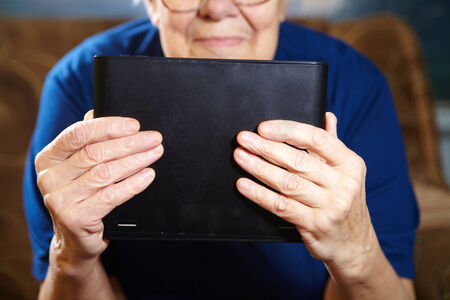 Elderly woman with tablet computer. Senior people using internetの写真素材
