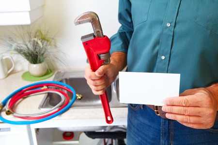Plumber with Plumbing tools on the kitchen. Renovation.の写真素材