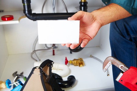 Plumber with Plumbing tools on the kitchen. Renovation.の写真素材