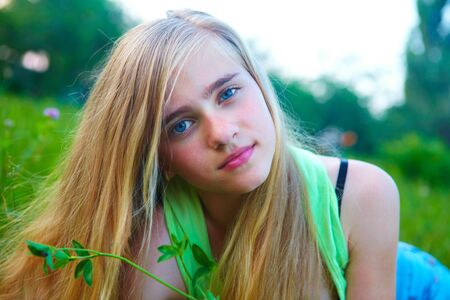 Young girl in the garden. On the lawnの写真素材