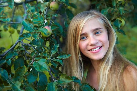 Young girl in the garden. Girl and apple-treeの写真素材