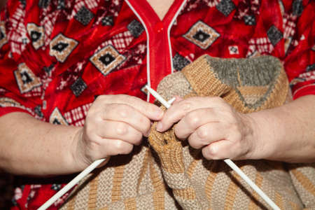 Old woman and knitting sweater. Senior peopleの写真素材