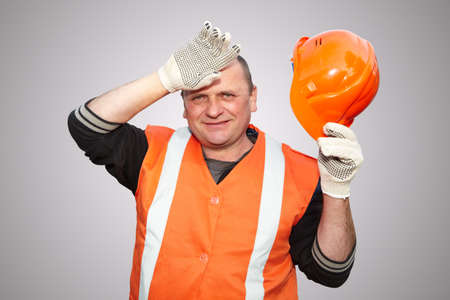 Contractor working with helmet on grey backgroundの写真素材