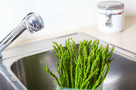 Vegetarian food in the sink. Fresh asparagusの写真素材