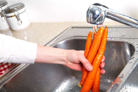 Red carrot in the sink. Fresh carrotの写真素材