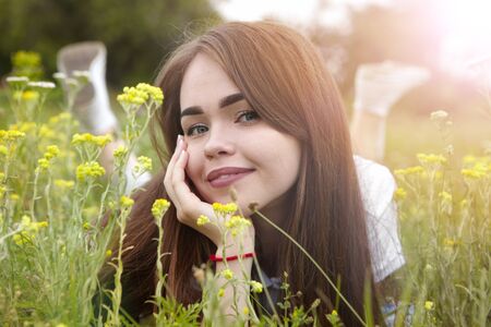 The girl in the sunny morning in a meadow