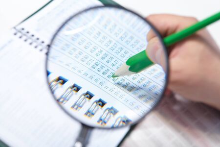 Businessman working in the office. The magnifier