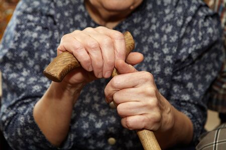 Old woman hands with cane. Senior people health careの写真素材
