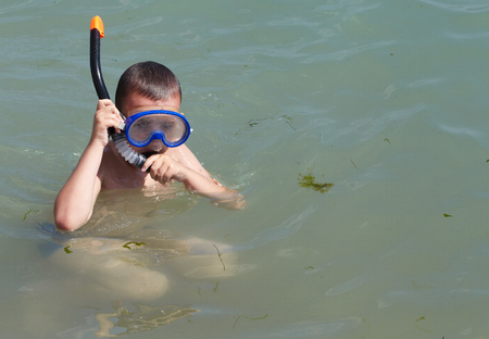 Little boy in mask for diving in the seaの写真素材