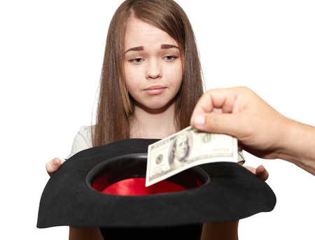 Young girl asks for alms on a white backgroundの写真素材