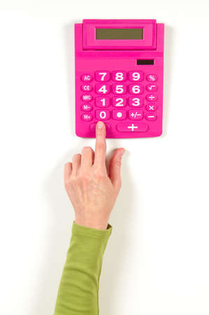 Hands in green jacket and red calculator on white backgroundの写真素材