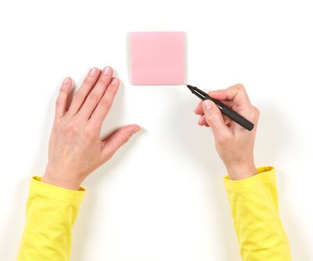 Hand and red paper on the table on white background