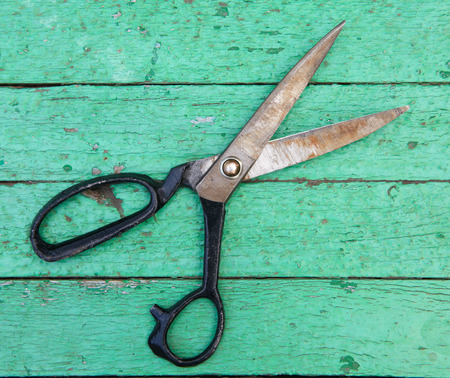 Old shears on wooden background. Construction conceptの写真素材