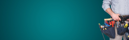 Mature contractor working. Over green background. Workerの写真素材