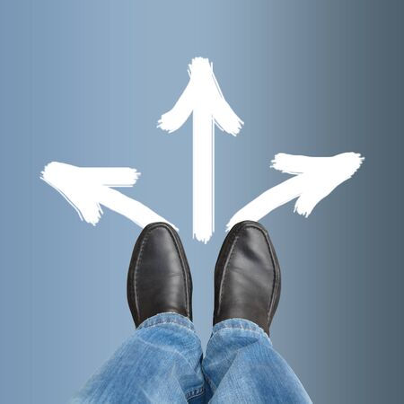 Man in shoes ponders which way to go