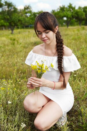 The girl in the sunny morning in a meadowの写真素材
