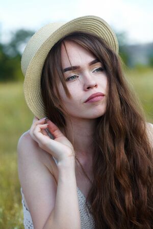 The girl in the sunny morning in a meadowの写真素材