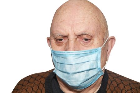 Elderly man in a medical mask on whiteの写真素材