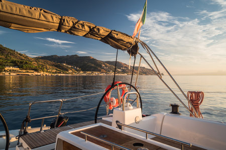 View from deck of sailing boat with rudder and italian flag