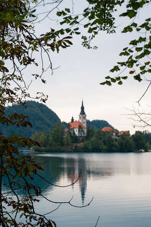 Church on island on lake Bled in cloudy weatherの写真素材