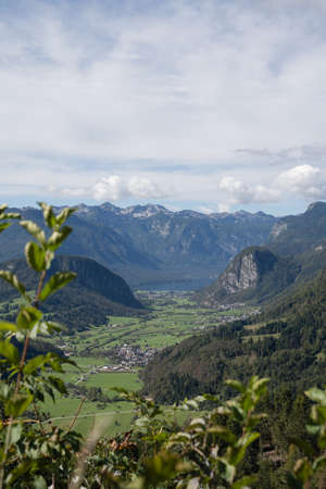 View over plain between mountains and Lake Bohinjの写真素材