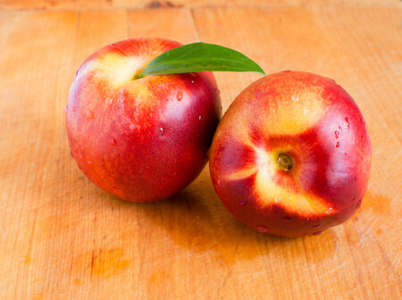 peach on a wooden backgroundの写真素材