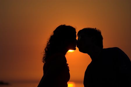 Young couple is kissing on the beachの写真素材
